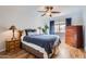 Bedroom with a wood bedframe, wood floors, plants and a ceiling fan at 7940 E Camelback Rd # 403, Scottsdale, AZ 85251