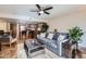 Open-concept living area featuring a comfortable couch, plants and kitchen access at 7940 E Camelback Rd # 403, Scottsdale, AZ 85251