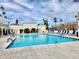 Large outdoor pool with crystal clear water and ample seating surrounded by shade umbrellas at 7940 E Camelback Rd # 403, Scottsdale, AZ 85251