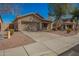 Tan single-story home with well maintained landscaping and a driveway leading to an attached garage at 817 S 123Rd Dr, Avondale, AZ 85323