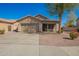 Charming single-story home featuring a two-car garage, desert landscaping, and a covered front porch at 817 S 123Rd Dr, Avondale, AZ 85323