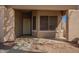 Covered front porch with desert landscaping and an ornate front door at 817 S 123Rd Dr, Avondale, AZ 85323