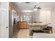 Bright kitchen featuring stainless steel appliances, tile floors, and a breakfast bar at 817 S 123Rd Dr, Avondale, AZ 85323