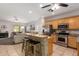 Eat-in kitchen with barstool seating, stainless appliances, and granite countertops at 817 S 123Rd Dr, Avondale, AZ 85323