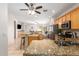 Open kitchen with barstool seating, stainless appliances, and views to the living room at 817 S 123Rd Dr, Avondale, AZ 85323