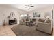 Inviting living room features tile floors, comfortable seating, and sliding door access to the backyard at 817 S 123Rd Dr, Avondale, AZ 85323