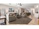 Spacious living room with comfortable seating, ceiling fan and views into the kitchen and backyard at 817 S 123Rd Dr, Avondale, AZ 85323