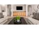 Living room featuring tile flooring, neutral colored furniture, and a wall mounted TV at 817 S 123Rd Dr, Avondale, AZ 85323