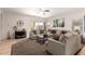 Open-concept living room features neutral tones, tile flooring, and a sliding glass door leading to the backyard at 817 S 123Rd Dr, Avondale, AZ 85323