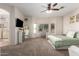 Relaxing main bedroom with a work area, ensuite bathroom, and carpeted floors at 817 S 123Rd Dr, Avondale, AZ 85323