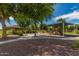Community playground with a shaded play structure, picnic gazebo, and mature trees at 817 S 123Rd Dr, Avondale, AZ 85323