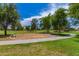 Community park featuring a swing set, lush green lawn, and mature shade trees at 817 S 123Rd Dr, Avondale, AZ 85323