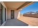 Back porch with sliding glass door, offering access to a spacious dirt backyard at 855 W Peralta Pass, Apache Junction, AZ 85120