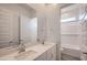 Bathroom featuring a dual sink vanity, and a shower-tub combination with white tiles at 855 W Peralta Pass, Apache Junction, AZ 85120