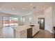 Modern, open-concept kitchen features an island, stainless steel appliances, and bright, neutral finishes at 855 W Peralta Pass, Apache Junction, AZ 85120