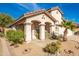 Beautiful single-story home featuring desert landscaping, a covered porch, and arched entryways at 8884 E Arizona Park Pl, Scottsdale, AZ 85260