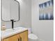 Stylish half-bathroom featuring a wood vanity, modern sink, and artistic wall decorations at 9167 E Tarantini Ln, Scottsdale, AZ 85260