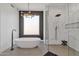 Modern bathroom featuring a standalone tub, a glass shower, and tile flooring at 9167 E Tarantini Ln, Scottsdale, AZ 85260
