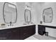 Bathroom featuring dual sinks with dark cabinetry, rectangle mirrors, and modern lighting at 9167 E Tarantini Ln, Scottsdale, AZ 85260
