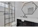 Modern bathroom with glass enclosed shower, black fixtures, and sleek vanity at 9167 E Tarantini Ln, Scottsdale, AZ 85260
