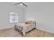 Cozy bedroom with simple décor, wood floors, ceiling fan, and a bright window at 9167 E Tarantini Ln, Scottsdale, AZ 85260
