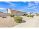 Exterior view of a home featuring a two-car garage and desert landscaping at 9167 E Tarantini Ln, Scottsdale, AZ 85260