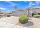 Exterior of a home showcasing a two-car garage, desert landscaping, and a paved driveway at 9167 E Tarantini Ln, Scottsdale, AZ 85260