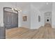Bright foyer with hardwood flooring, a modern chandelier, and stylish double front doors at 9167 E Tarantini Ln, Scottsdale, AZ 85260