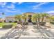 Inviting single-story home with palm trees and a neutral-toned exterior, set against a beautiful blue sky at 9167 E Tarantini Ln, Scottsdale, AZ 85260