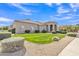 Well-maintained front yard featuring lush green grass and desert landscaping with bright blue skies at 9167 E Tarantini Ln, Scottsdale, AZ 85260