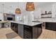 Modern kitchen features an island with marble countertop and stainless steel appliances and stylish pendant lighting at 9167 E Tarantini Ln, Scottsdale, AZ 85260