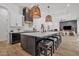 Spacious kitchen with a large island, modern lighting, and stainless steel appliances at 9167 E Tarantini Ln, Scottsdale, AZ 85260