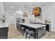 Bright, modern kitchen featuring a large island with seating and stylish pendant lighting at 9167 E Tarantini Ln, Scottsdale, AZ 85260