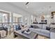 Open-concept living room and kitchen featuring hardwood floors, modern furniture, and stylish decor at 9167 E Tarantini Ln, Scottsdale, AZ 85260