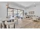 Bright open-concept living space with hardwood floors and large sliding glass doors to the patio at 9167 E Tarantini Ln, Scottsdale, AZ 85260
