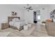 A main bedroom with light wood floors and neutral decor leads to an arched hallway at 9167 E Tarantini Ln, Scottsdale, AZ 85260