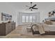 Main bedroom features a ceiling fan, wood floors, and lots of natural light from bay windows at 9167 E Tarantini Ln, Scottsdale, AZ 85260