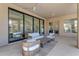 Covered patio with comfortable seating, ceiling fan, and seamless indoor-outdoor living at 9167 E Tarantini Ln, Scottsdale, AZ 85260
