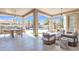 Covered patio with outdoor seating, dining area, and views of the pool and landscaped backyard at 9167 E Tarantini Ln, Scottsdale, AZ 85260