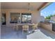 Covered patio with outdoor kitchen, dining area, ceiling fan, and backyard views at 9167 E Tarantini Ln, Scottsdale, AZ 85260