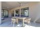 Covered patio with a dining table, ceiling fan and views of the beautifully landscaped backyard at 9167 E Tarantini Ln, Scottsdale, AZ 85260