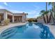 Beautiful backyard pool with mature palm trees, lush landscaping, and outdoor living space at 9167 E Tarantini Ln, Scottsdale, AZ 85260
