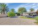 Expansive backyard with lush green lawns and mature trees at 9401 W Raintree Dr, Sun City, AZ 85351