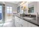 Modern bathroom featuring dual sinks and sleek countertop finishes at 9401 W Raintree Dr, Sun City, AZ 85351