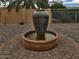 Beautiful water fountain feature in a landscaped yard, providing a focal point and tranquil ambiance at 9401 W Raintree Dr, Sun City, AZ 85351