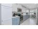 Modern kitchen with stainless steel appliances, stylish cabinetry, and tile flooring at 9401 W Raintree Dr, Sun City, AZ 85351