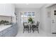 Cozy breakfast nook near a bright window with seating for two at 9401 W Raintree Dr, Sun City, AZ 85351