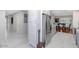 Spacious kitchen with stainless steel appliances, white cabinets, and hallway access at 9401 W Raintree Dr, Sun City, AZ 85351