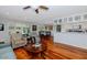 Bright living area with hardwood floors, dining table, and a view of the kitchen at 9401 W Raintree Dr, Sun City, AZ 85351