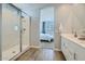 Modern bathroom featuring a glass-enclosed shower and a double sink vanity with white cabinets and wood-look tile flooring at 9718 S Centennial Rd, Apache Junction, AZ 85120